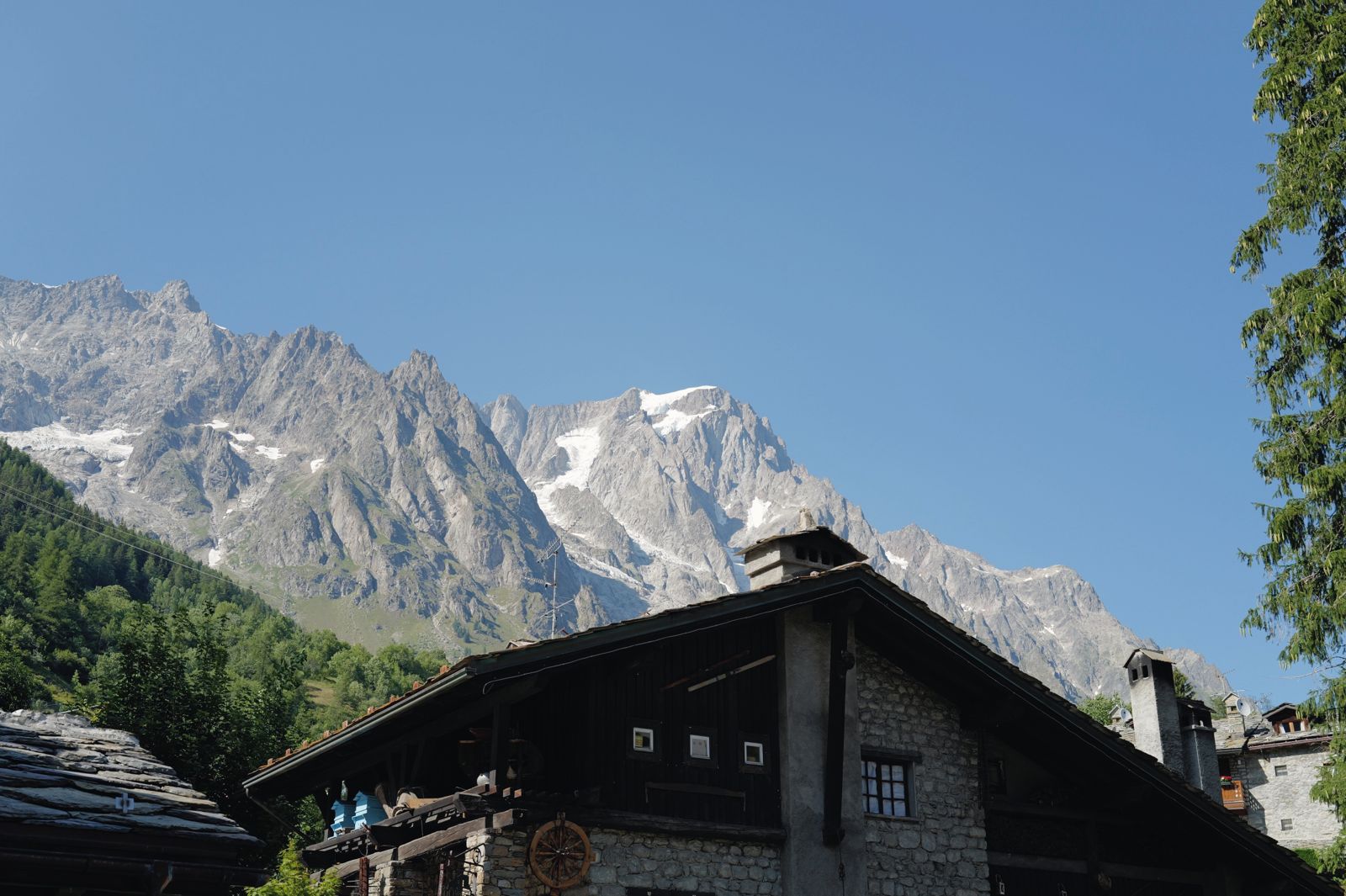 Granite peaks above a stone chalet
